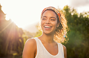 Beautiful Black woman smiling after getting Invisalign at Riverwind Dental in Richmond, VA 