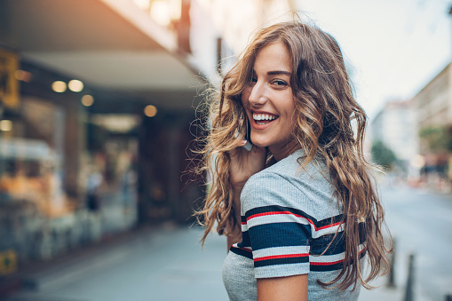 CollegeGirlLaughingoverhershoulder GettyImages 821889372