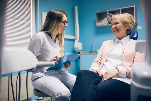 Older Black couple speaking with dentist about condition at Riverwind Dental in Richmond, VA