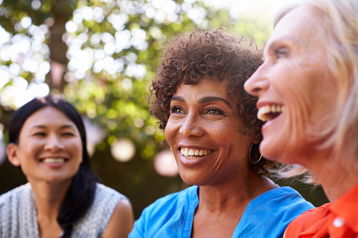 A group of smiling older women with dental implants from Riverwind Dental in Richmond, VA