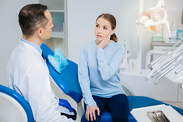 Dentist speaking with patient about mouth sore at Riverwind Dental in Richmond, VA