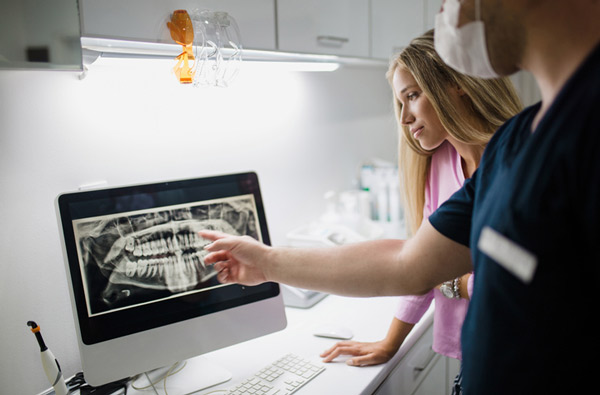 A dentist reviewing a digital x-ray at Riverwind Dental in Richmond, VA