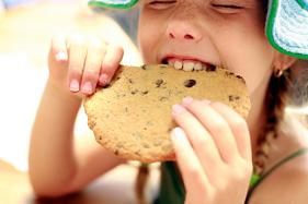 Photo of girl eating junk food that is not approved at Riverwind Dental in Richmond, VA