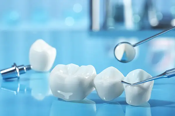 A dental bridge sitting on a clean table at Riverwind Dental in Henrico, VA